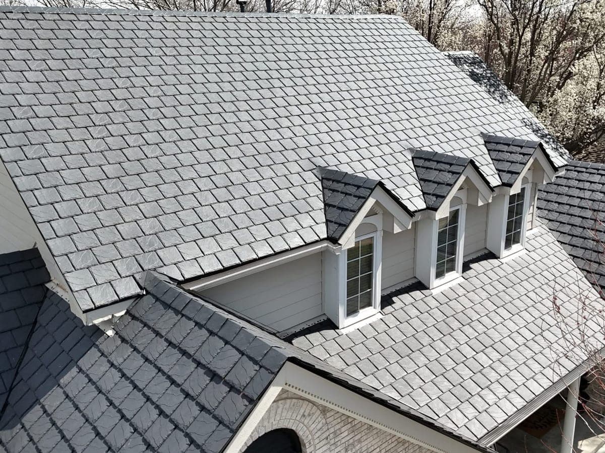 Completed slate-look shingle roof with dormers, seen from above